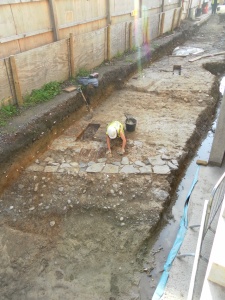 GGAT archaeologist cleaning the stonework revetting of the forts defensive bank